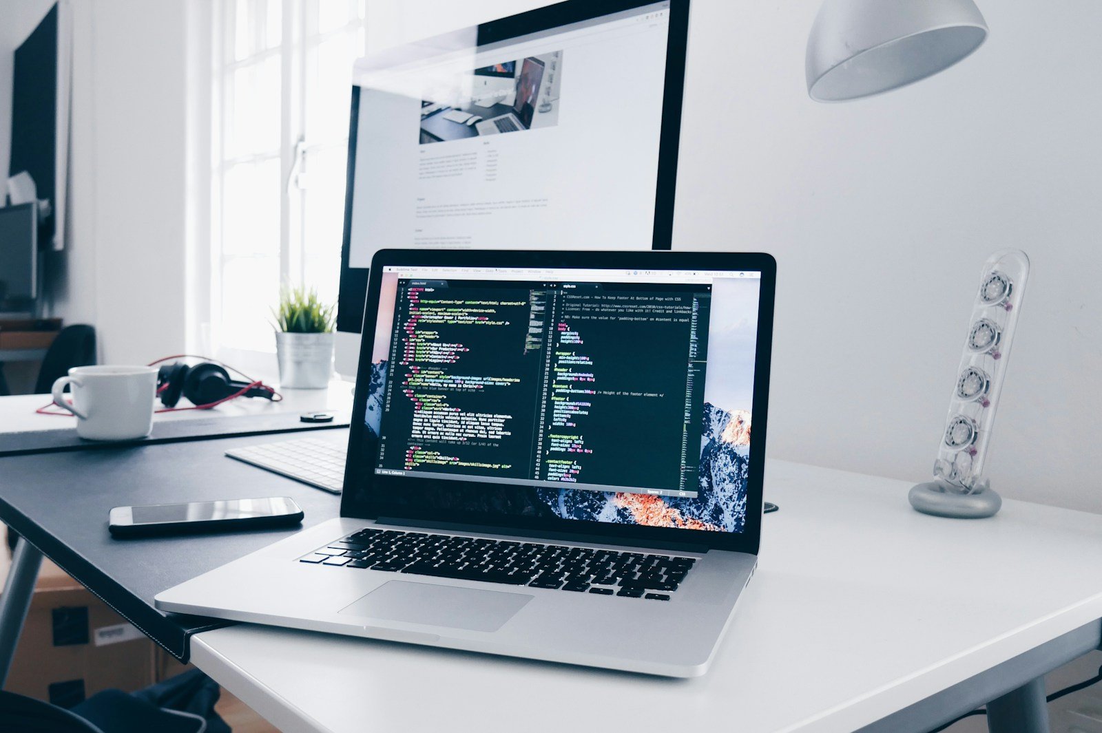Laptop with a code editor at a development workspace